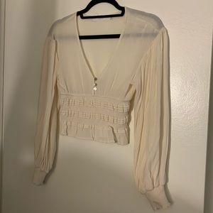 Cream colored long sleeve cropped top